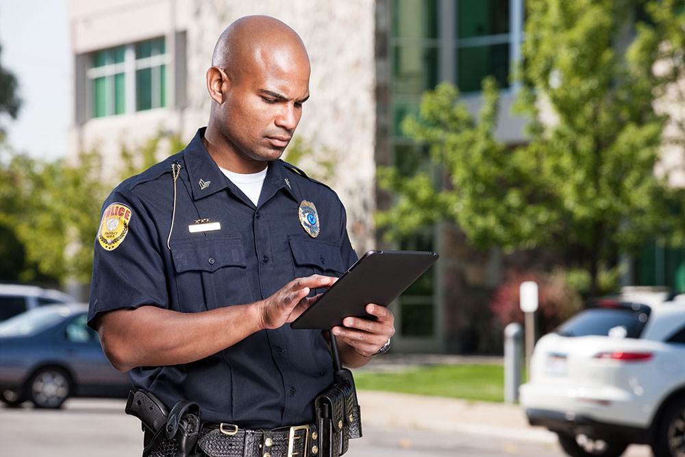 Police officer using a tablet outdoors